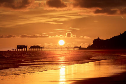 Cromer Pier in early morning light with gentle waves Norfolk