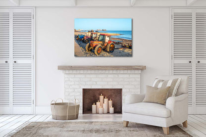 Traditional crab fishing tractors on Cromer beach with pier in background
