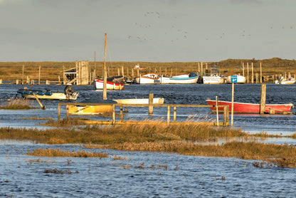 Boats along Morston harbour with marshland beyond on the North Norfolk coast