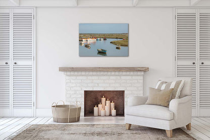 Moored boats at a bend in Morston creek with salt marsh landscape