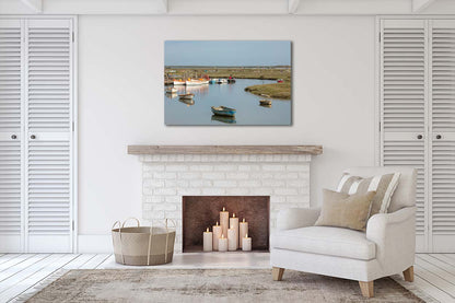 Moored boats at a bend in Morston creek with salt marsh landscape