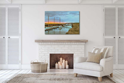 Dawn light over Morston Quay harbour with boats and still water