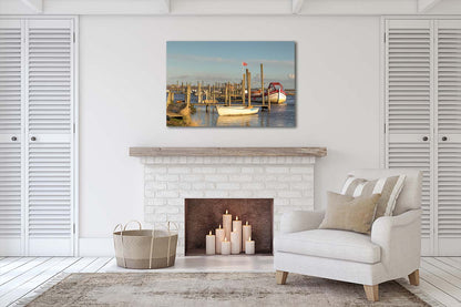 Golden light over Morston Quay with harbour posts, boats and soft reflections