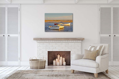 Morston Quay harbour scene with boats on the tidal creek and wide marsh sky